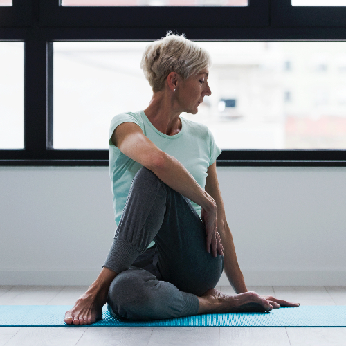 holistic-women twisting stretch-a-stretch-PhysioCare-Rehab-and-Wellness-Brandywine-MD
